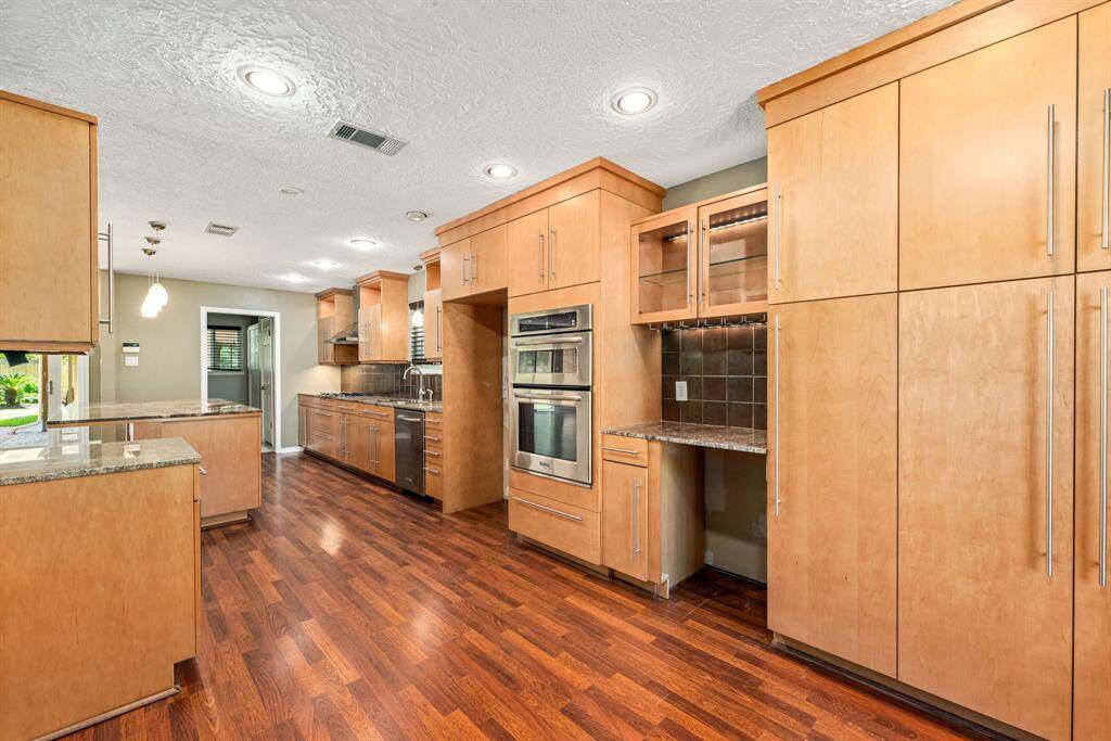 Just off the dining room is the gorgeous kitchen filled with extra cabinetry and a stemware rack.
