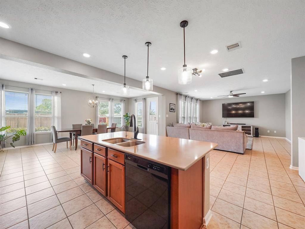Enjoy watching the TV while cooking in the Kitchen! Showcasing the homes Open Layout!