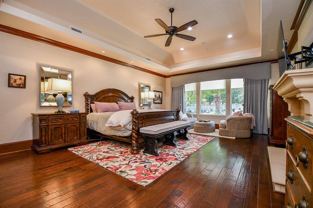 Large primary suite with hardwood floors, large closets overlooking the gorgeous backyard.