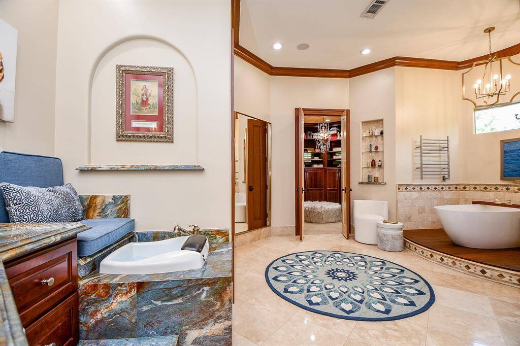 Large primary bath with your very foot bath, large tub and shower with doors on both her and his sides.