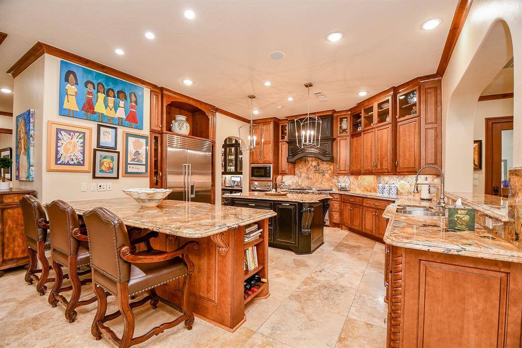 Kitchen is centrally located with 6 burner cooktop and a gridle, pot filler, built in refrigerator, oven and a warming drawer, 2 dishwashers, under the cabinet lighting to list a few.