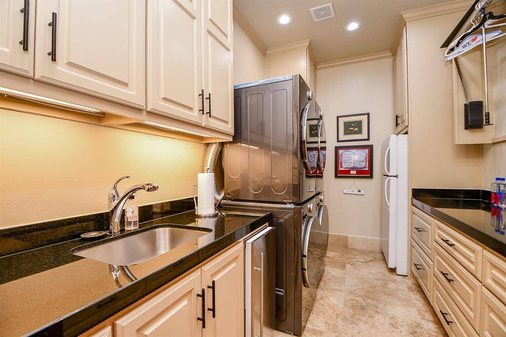 Spacious laundry room with great counterspace, room for a frig, ice maker and tons of drawers and cabinets for storage.