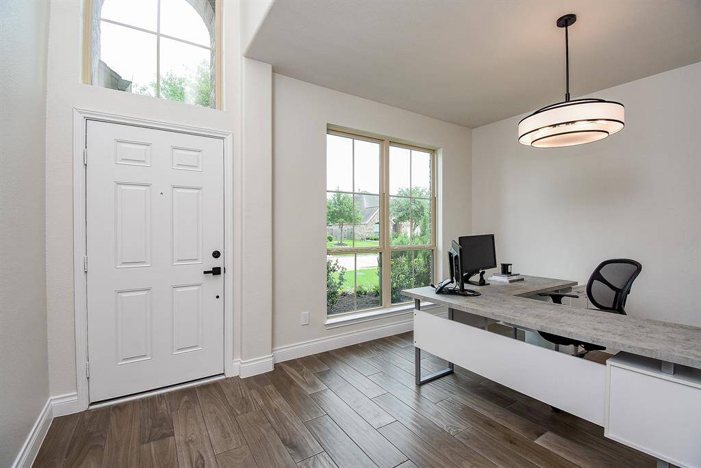 As you walk in, you are greeted with 18' high ceilings, wood-look tile flooring, and a bright, open, and welcoming atmosphere. Large windows allow abundant natural light into your home.