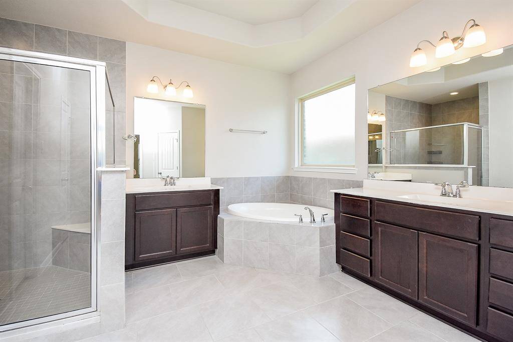 Dual vanities in your en-suite primary bath, offer personal space with dedicated cabinet space.