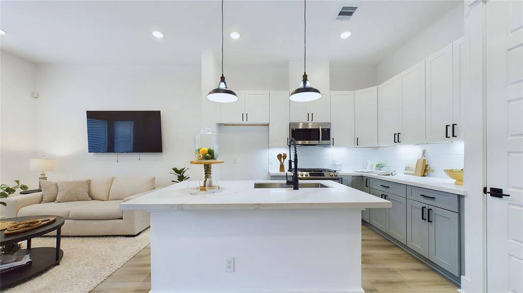 This spacious kitchen offers ample cabinetry, providing plenty of space for storage.