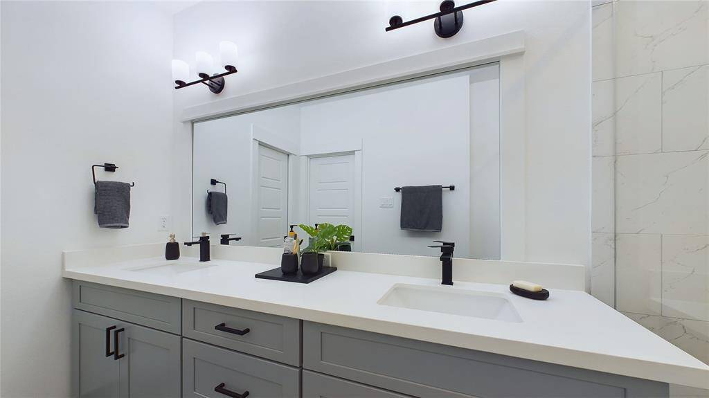 Primary bathroom with quartz double-sink vanity