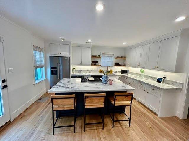 Open floor design from den to kitchen allows for entertaining or day-to-day togetherness.
