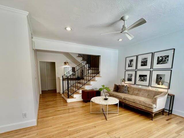 The den is bathed in plentiful natural light with an inviting view of the pool.