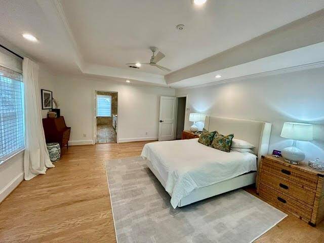 Large primary bath has double sinks, nice cabinet storage, and double walk-in closets with custom shelving.