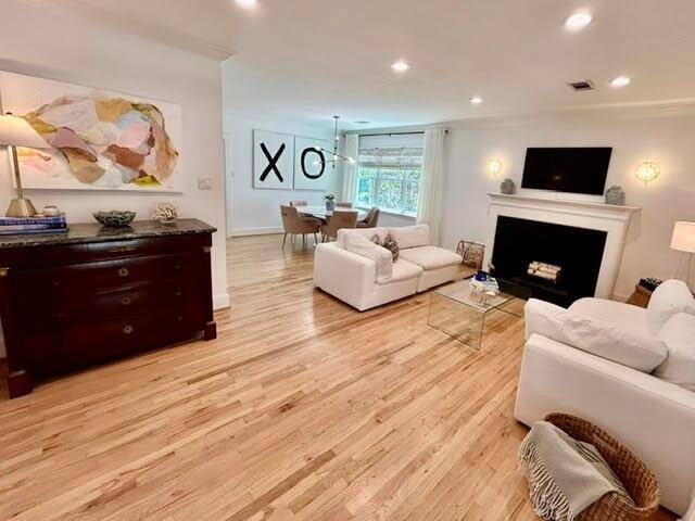 View of 25x14 Living Room with mock fireplace, and 10x10 Dining Room, from front entry.