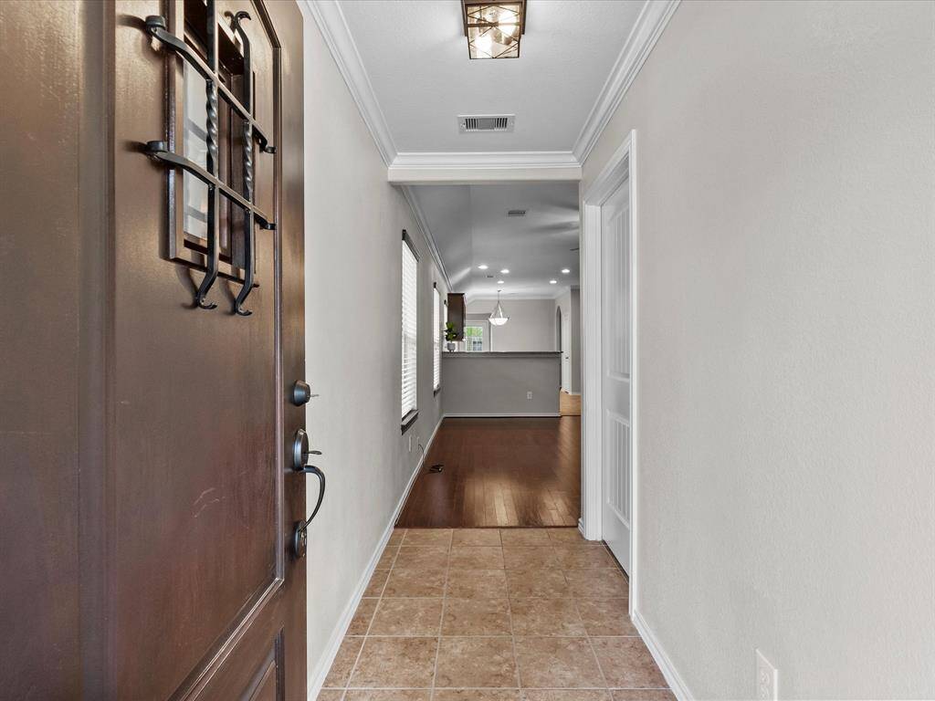 Beautiful wood front door with a charming wrought iron covered window full of character and the perfect welcome home.