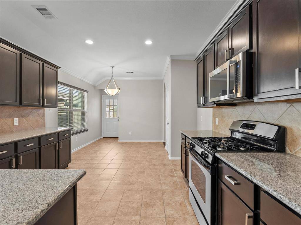 From kitchen to dining area, the flow is seamless - plus a convenient pantry tucked just to the right for easy access and storage.
