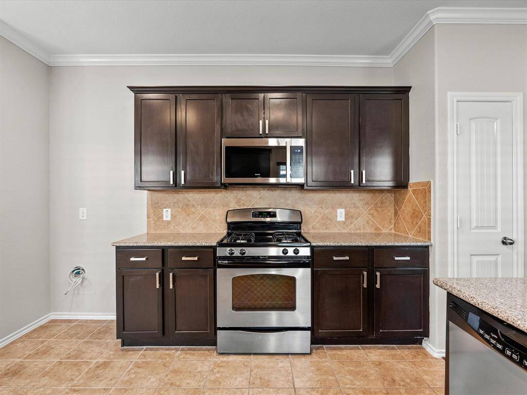 Room for a full size fridge, sleek granite countertops, gas stove, and even more cabinet space - plus a door to an extra closet for extra storage or pantry overflow.