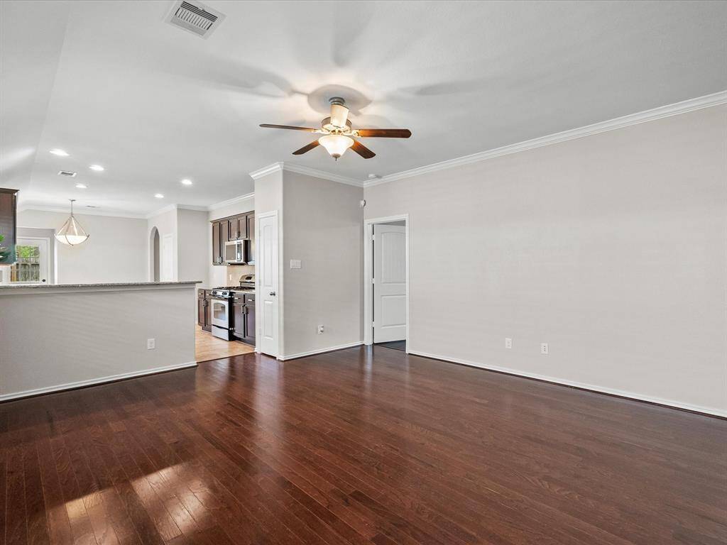 An open concept living room that flows seamlessly into the kitchen, with the primary suite just through the door for added comfort and convenience.