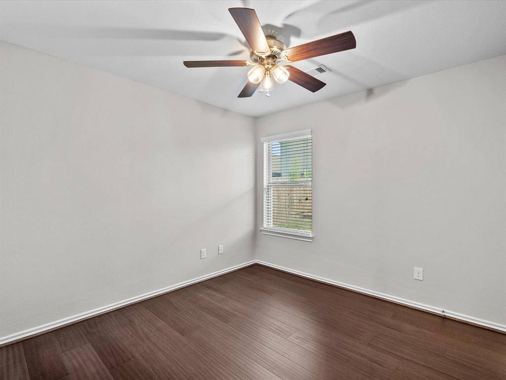 One of the secondary bedrooms, featuring bamboo flooring and a comfortable layout - perfect for family, guests, or a home office.