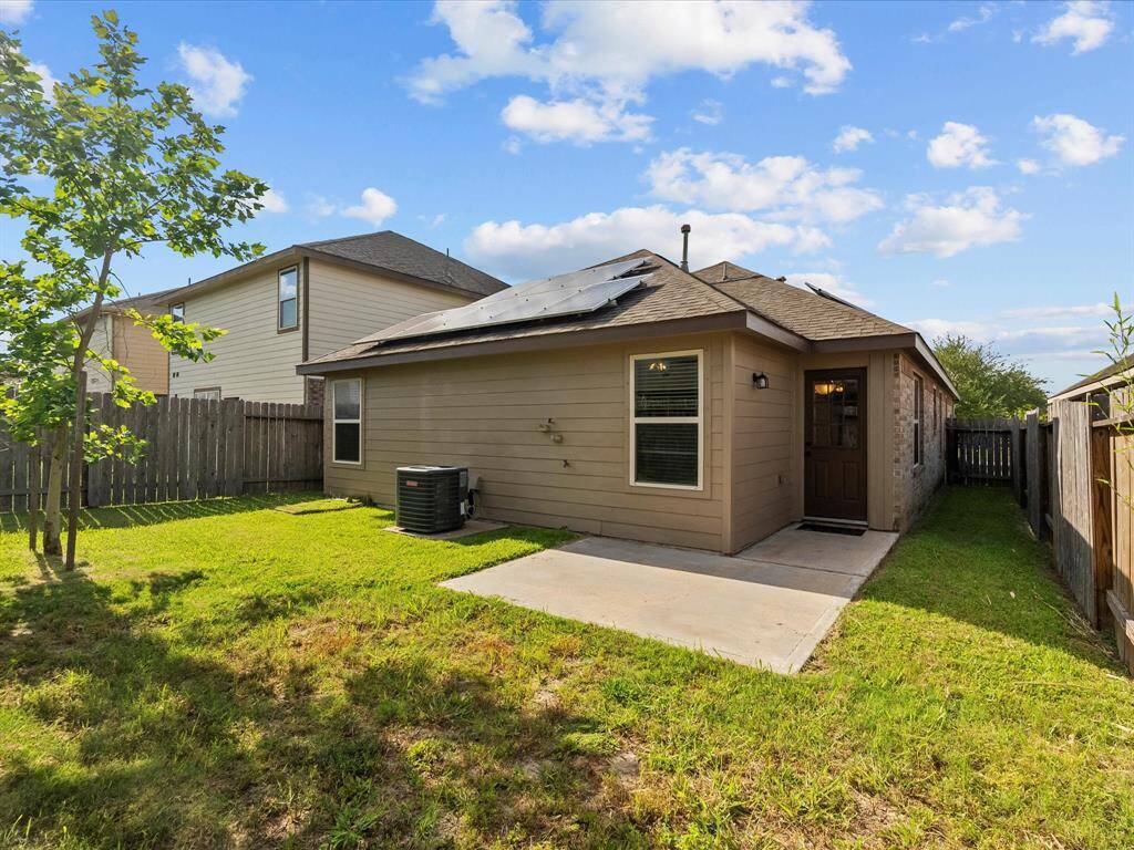 A look at the back of the home, featuring the porch - perfect for relaxing outdoors or grilling on the weekends - plus fully owned solar panels that bring lasting energy savings!