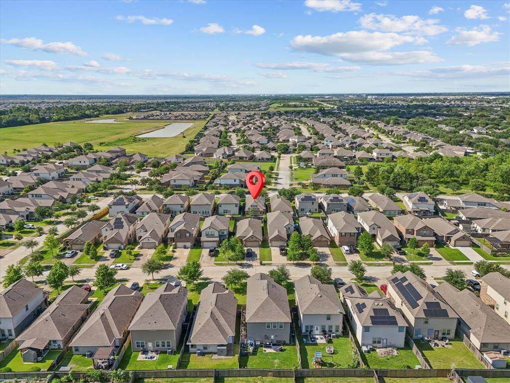 A view from behind the home showcasing the surrounding neighborhood - peaceful, well kept, and perfectly placed for everyday living. It's the kind of place where neighbors wave, and community feels like home!