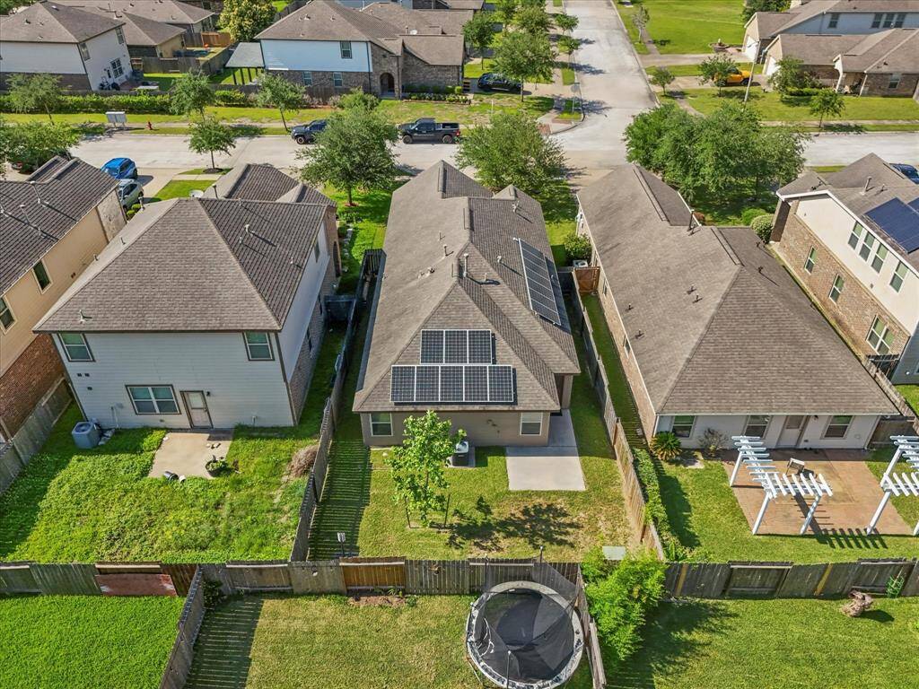 From above, the backyard shines complete with fully owned solar panels that bring energy savings and long-term peace of mind!