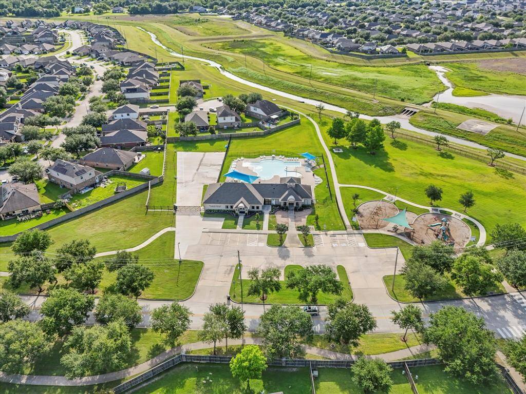 Just down the road, the community center buzzes with year round events - kids laughing at the splash pad, neighbors gathering by the pool, a welcoming park, and a peaceful stroll down the scenic walking trails!