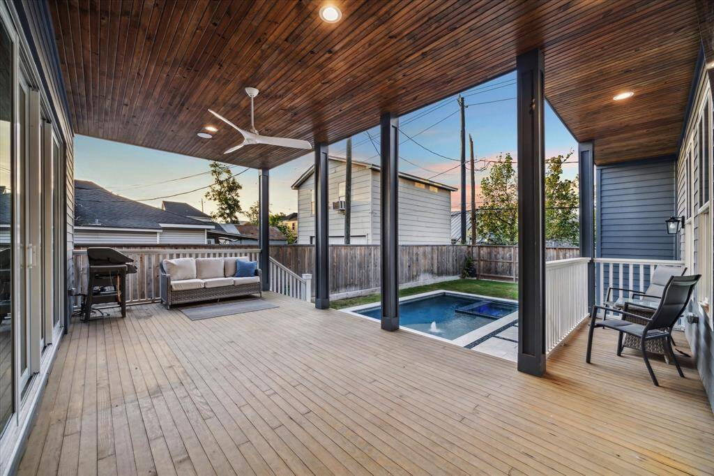 Huge covered back patio with tongue and groove stained wood ceiling