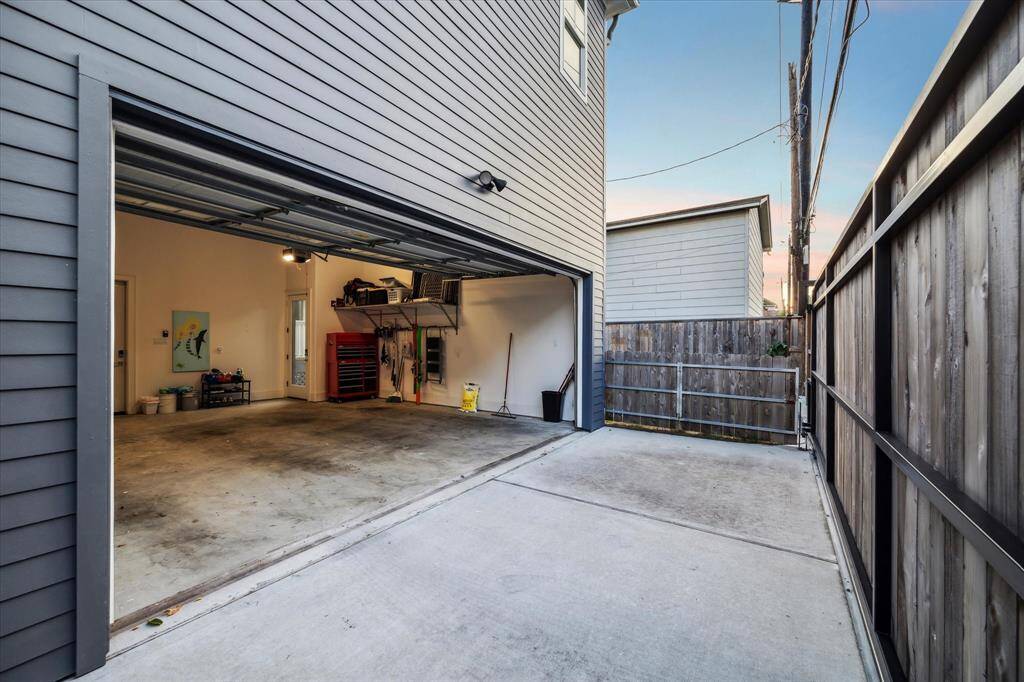Oversized garage, extra driveway behind custom driveway privacy gate - side gate will keep the pets and small kids inside the yard!