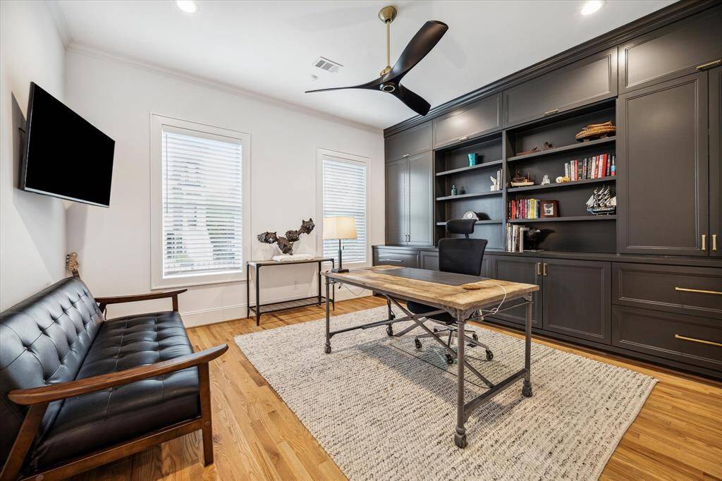 Accent wall of custom built-ins cause this home office / study to stand out