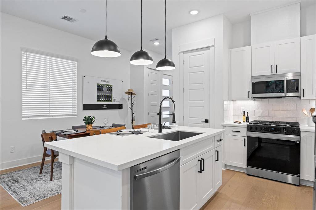 This attractive Kitchen is full of beautiful details. Quartz Countertops, Stainless steel Sink, Stainless Steel Appliances, Recessed Lighting, Undercabinet Lighting, Elegant Cabinetry with Soft Close Drawers and Doors