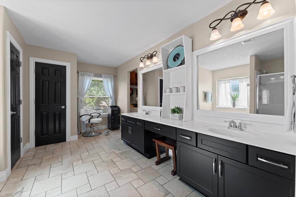 Double vanities, large linen closet and storage space.