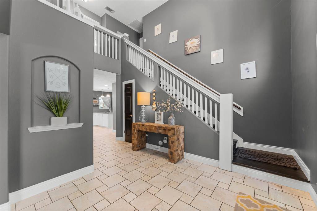 The first glimpse provides a view of the elegant interior with a two-story entrance.