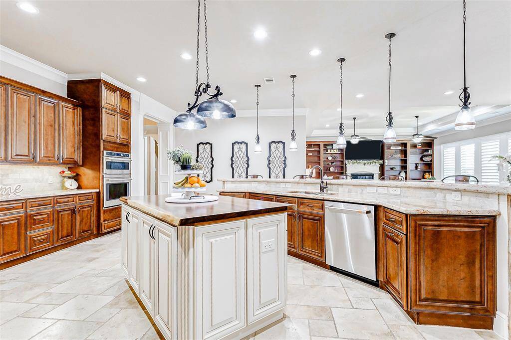 Under-cabinet lighting enhances the functionality of the space by providing ideal task lighting while also highlighting the beautiful backsplash and countertops, giving the entire kitchen a warm, welcoming glow.