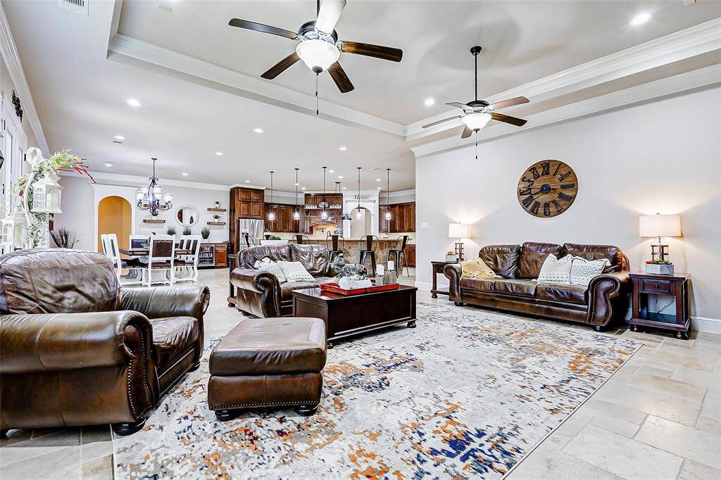 The open floor plan effortlessly transitions into the dining area and kitchen, creating a cohesive and inviting space perfect for both everyday living and entertaining.