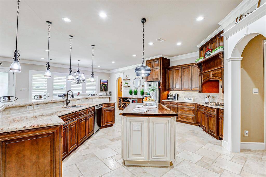 Thoughtful, built-in touches such as a dedicated pots and pans drawer, deep pull-out shelves, and soft-close drawers ensure that every tool and kitchen essential has its place. There is no shortage of storage here—ample cabinetry and well-placed drawers keep the space both functional and clutter-free, making it as efficient as it is beautiful.