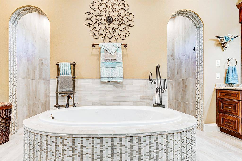 A deep soaking tub invites relaxation, ideal for unwinding after a long day.