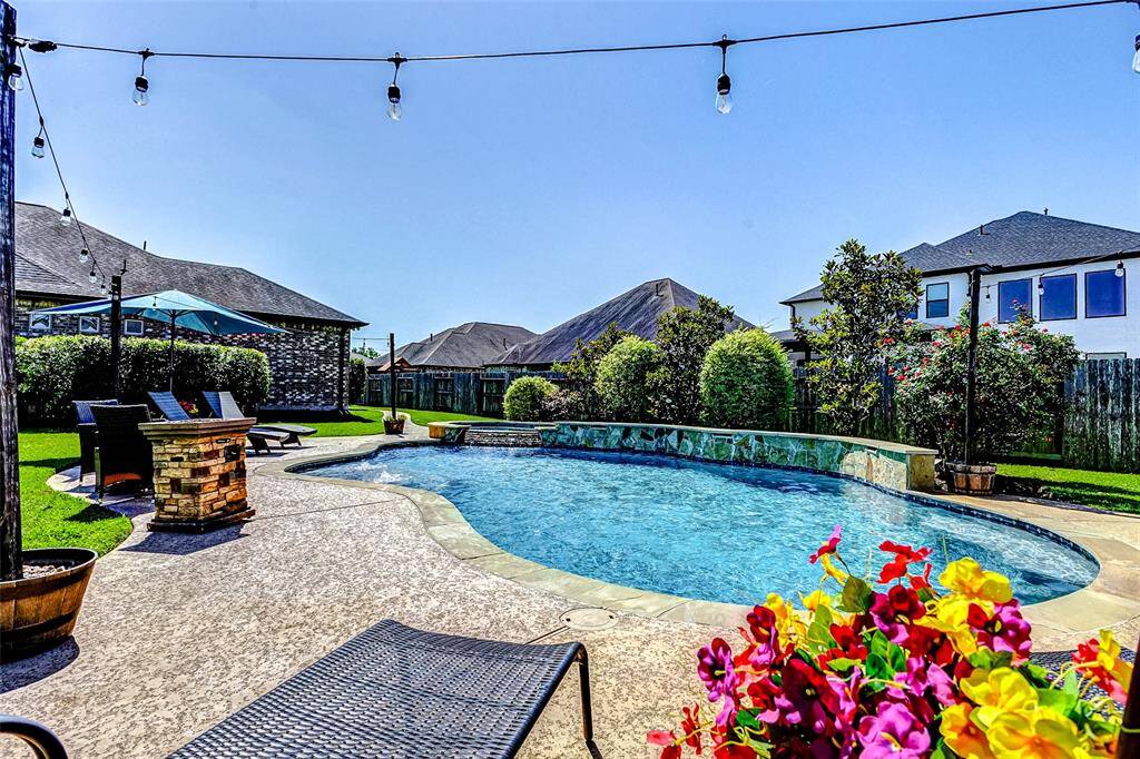 Just in time for summer, this absolutely stunning home—located on an expansive lot in The Reserve at Weston Lakes—features a spectacular pool and spa.