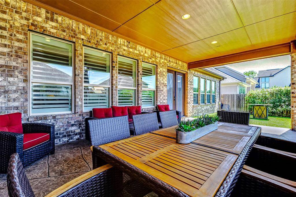This spacious patio provides ample room for both living and dining furniture, creating the perfect outdoor setting for relaxation and entertaining.