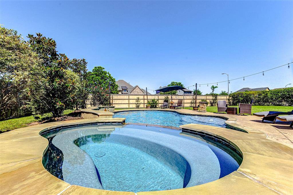 Just in time for summer, this refreshing pool is ready to enjoy. A beautiful flagstone patio surrounds the pool, offering plenty of space for lounge furniture, making it the perfect spot to relax, entertain, or soak up the sun.