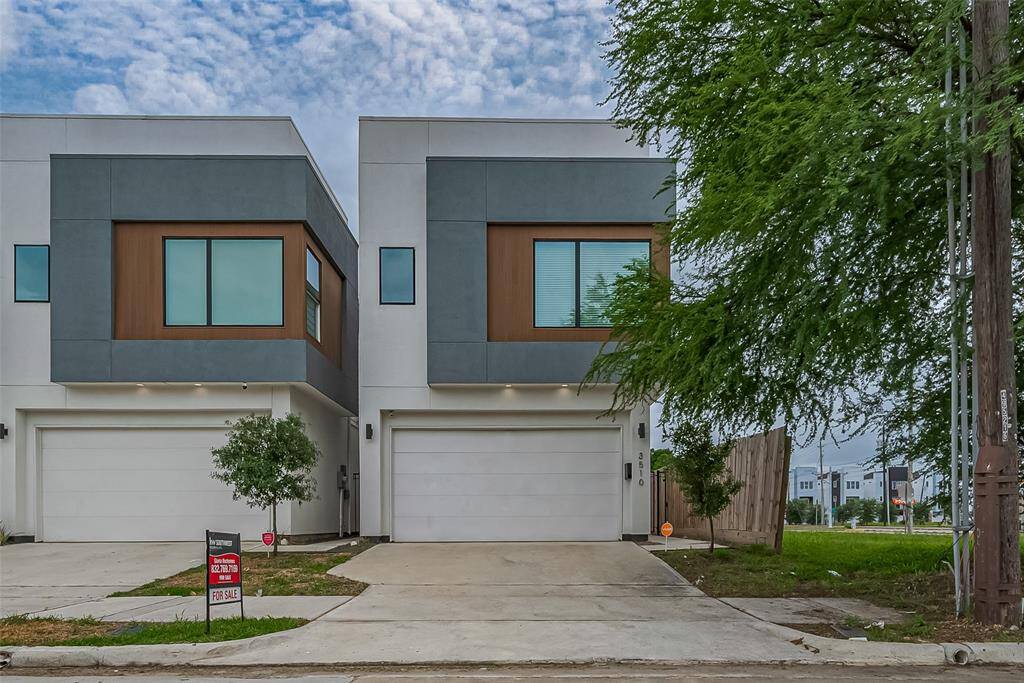 This striking two-story façade pairs geometric precision with layered tones for a crisp, modern look. The attached two-car garage is accented with sconce and recessed lighting, adding both function and flair to the architectural profile.