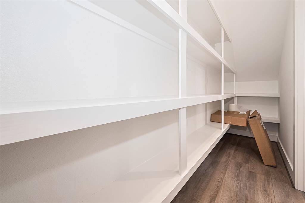 The full-size pantry offers expansive shelving and abundant storage, keeping the kitchen clutter-free and essentials within reach.
