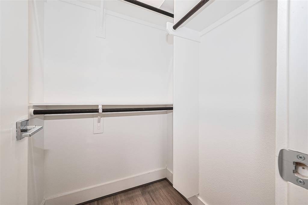 This closet offers custom-built racks and hanging rods, maximizing storage and keeping organization effortless.