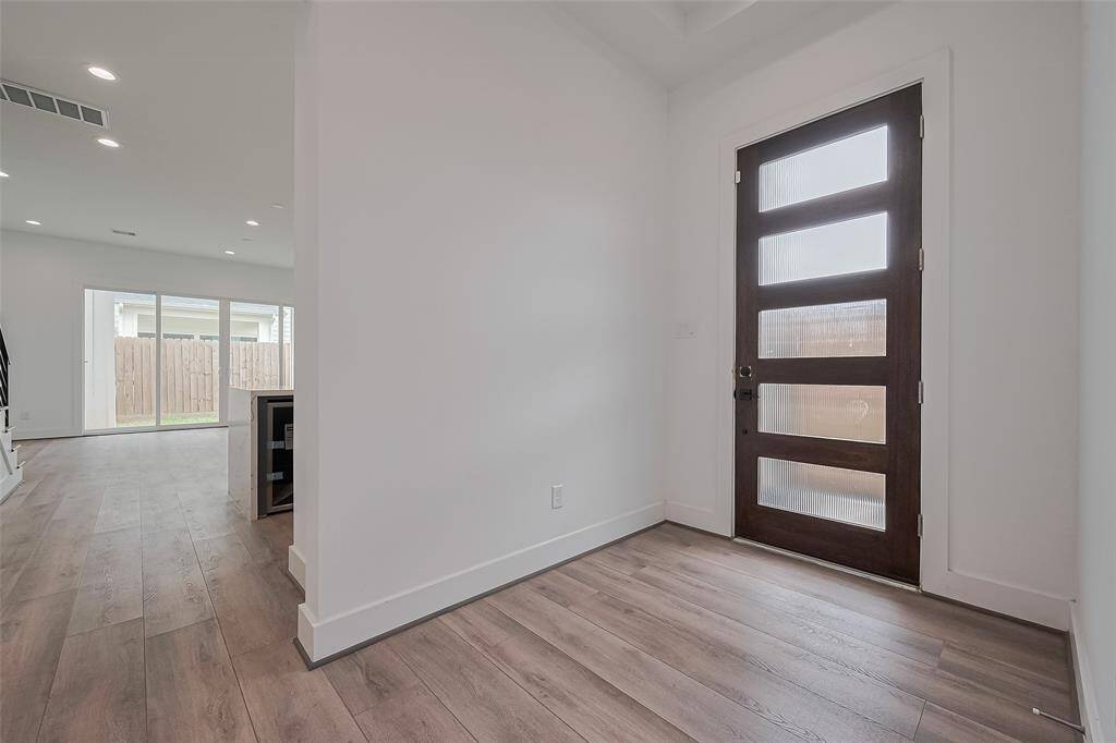 Step inside to a bright and welcoming foyer where natural light and clean sightlines guide you into the heart of the home. Just to the right, the open layout begins to unfold.