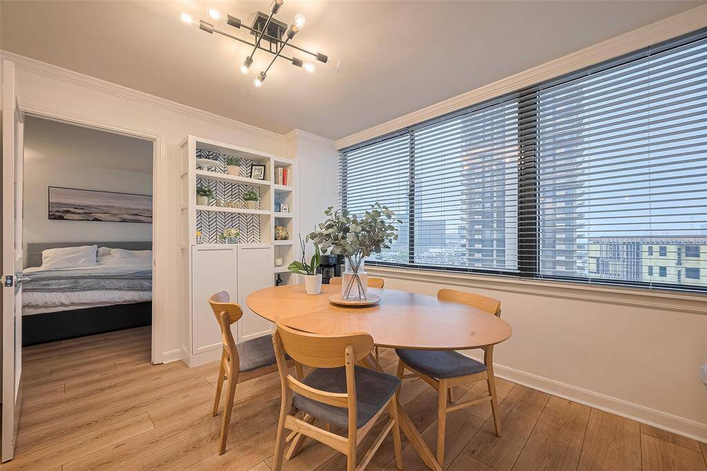 Positioned close to the expansive windows, the dining area offers a scenic setting for meals, with views of downtown Houston and the Galleria skyline.