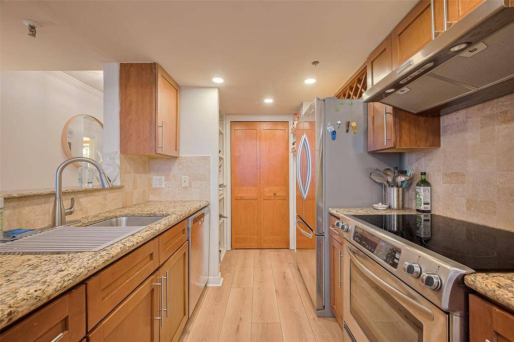 The kitchen features generous cabinetry and countertop space, providing a blend of functionality and aesthetic appeal for daily use or entertaining.