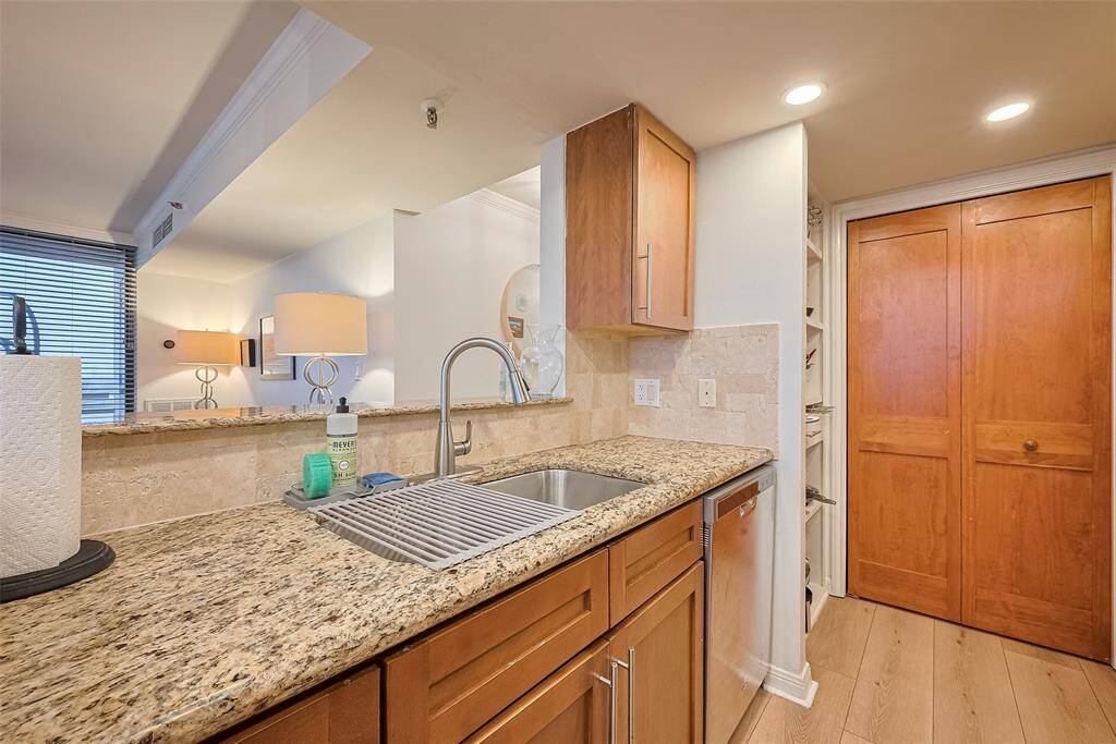 A raised bar counter subtly defines the kitchen while maintaining open sightlines into the living space.
