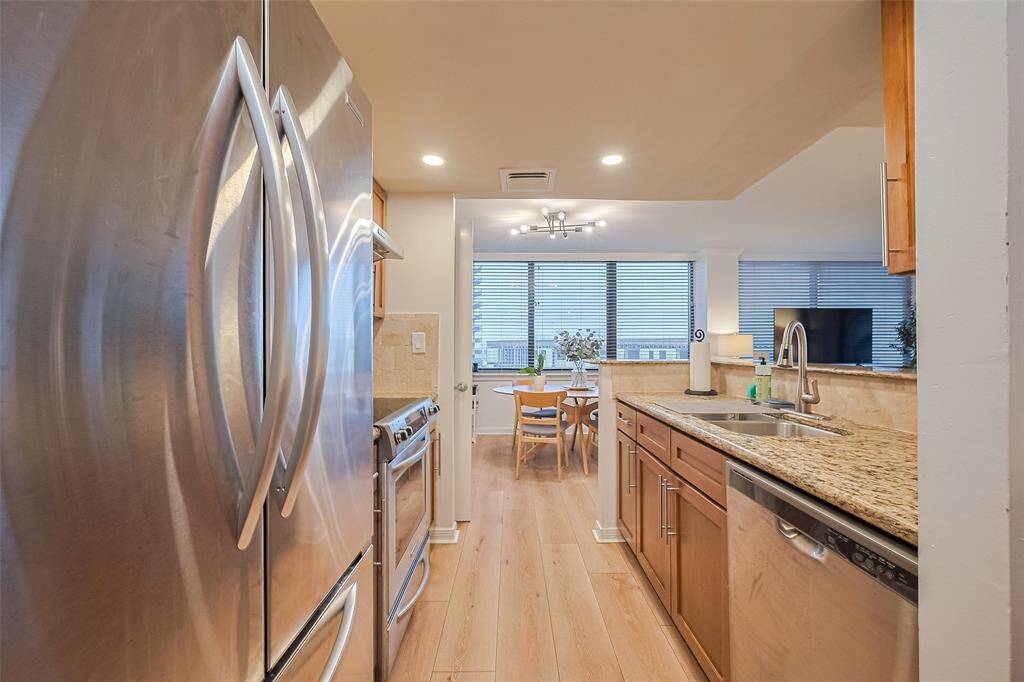 Appliances and cabinetry are thoughtfully arranged across parallel counters, creating an efficient and user-friendly cooking space.