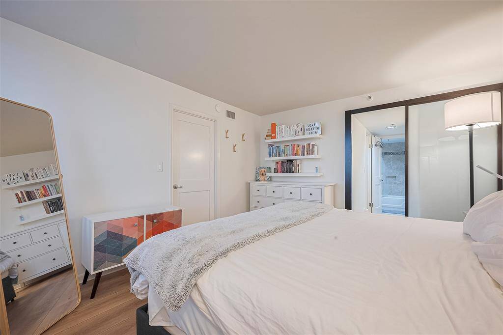 Sliding glass doors lead from the bedroom directly into the en suite, creating a smooth, stylish transition.
