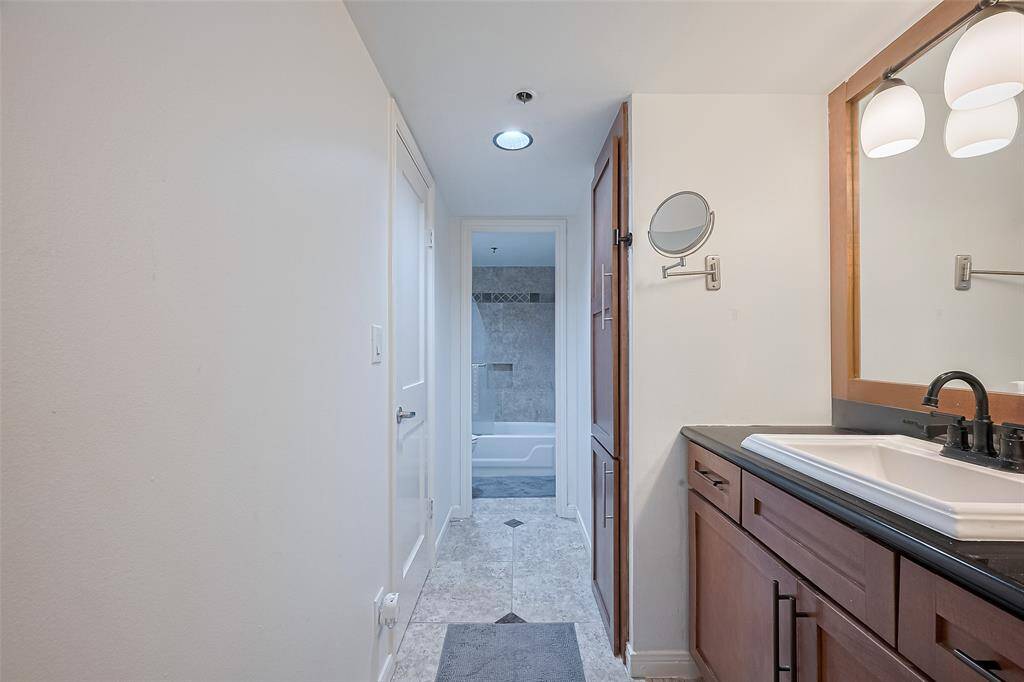 The separate vanity station adds convenience and privacy, ideal for preparing for the day with ease.