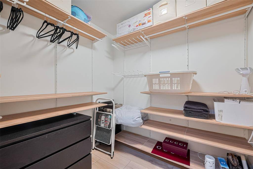 This full-entry closet features thoughtfully arranged built-in shelving, offering practical storage solutions without compromising elegance.