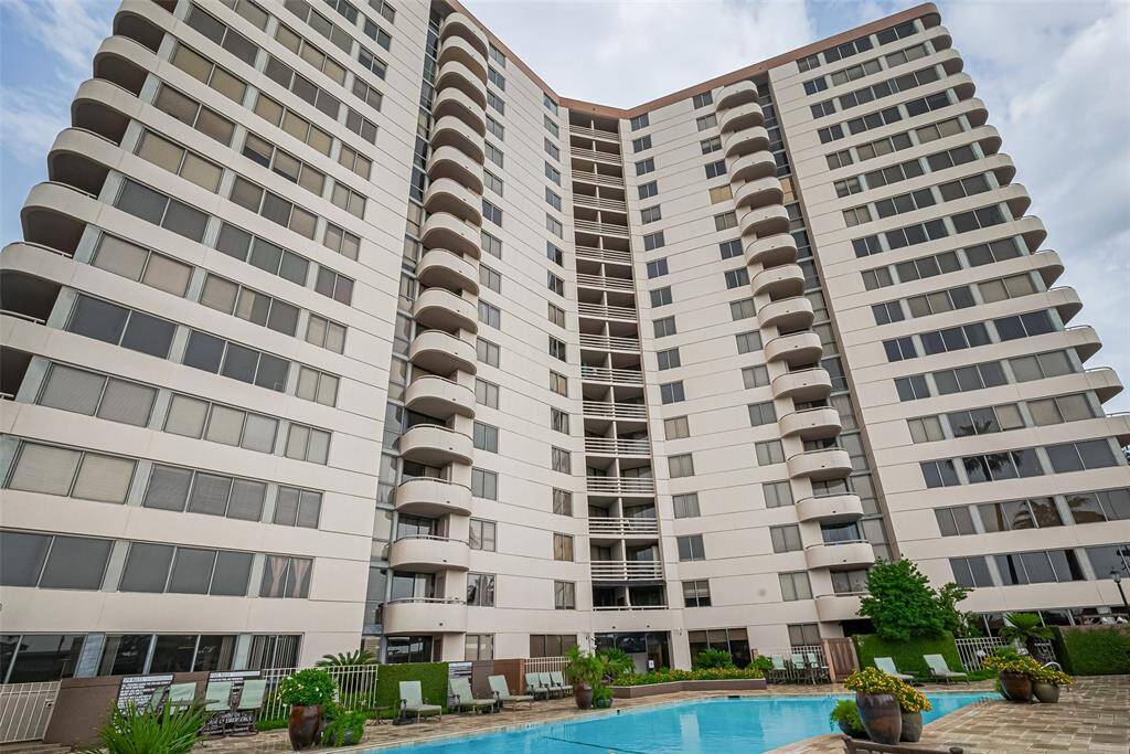 A view of the building’s rear facade, showcasing sleek architecture and manicured surroundings that reflect the community’s modern elegance.