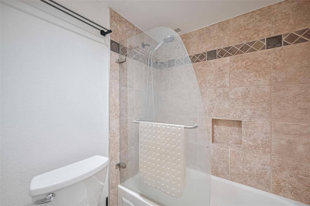 Featuring a lovely tile surround, the en suite tub-shower combination offers spa-like comfort at home.