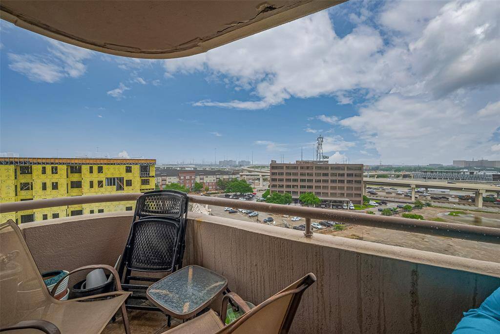 This alternate angle showcases the balcony as a perfect perch to relax or entertain above the city's energy.